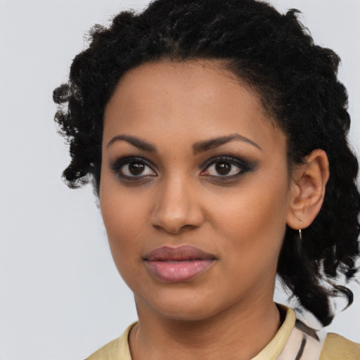 Joyful black young-adult female with medium  black hair and brown eyes