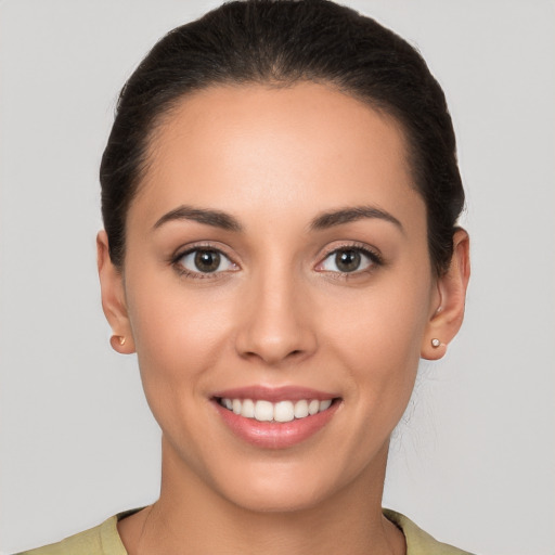 Joyful white young-adult female with short  brown hair and brown eyes