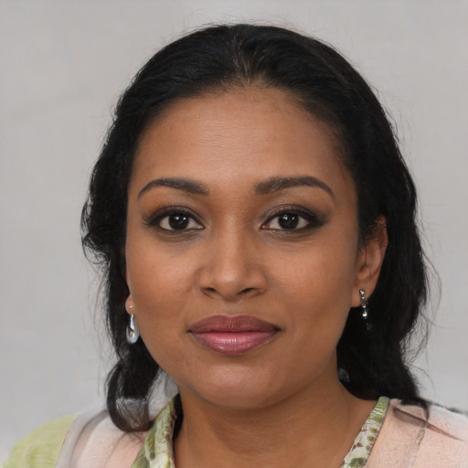 Joyful black young-adult female with medium  brown hair and brown eyes