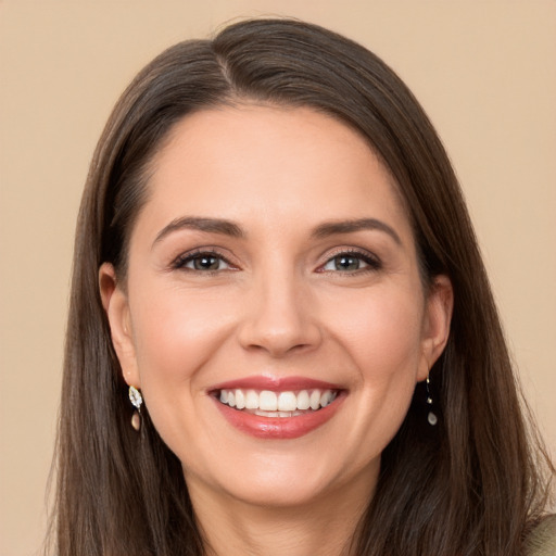 Joyful white young-adult female with long  brown hair and brown eyes