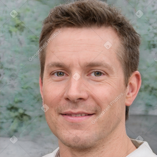 Joyful white adult male with short  brown hair and grey eyes