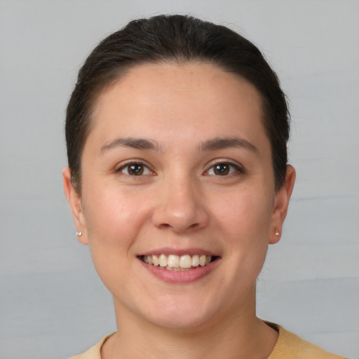 Joyful white young-adult female with short  brown hair and brown eyes