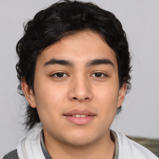 Joyful white young-adult male with medium  black hair and brown eyes