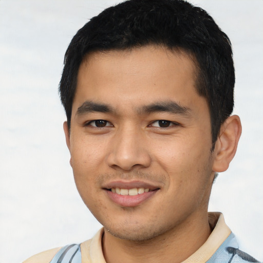 Joyful asian young-adult male with short  black hair and brown eyes