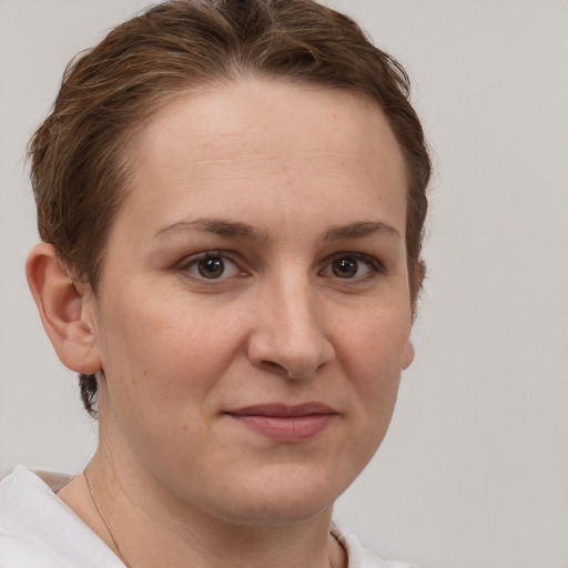 Joyful white adult female with short  brown hair and grey eyes