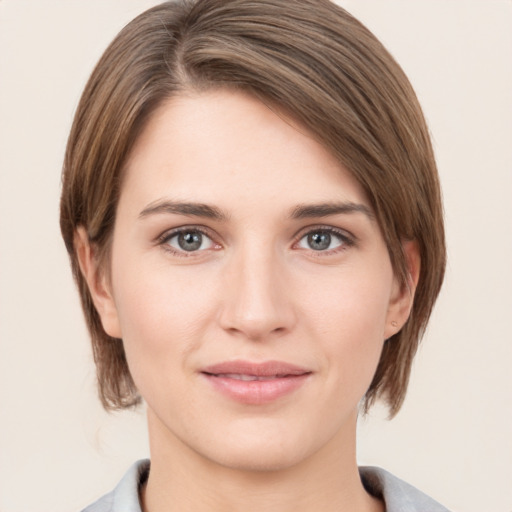 Joyful white young-adult female with medium  brown hair and grey eyes