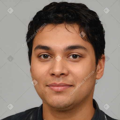 Joyful latino young-adult male with short  black hair and brown eyes