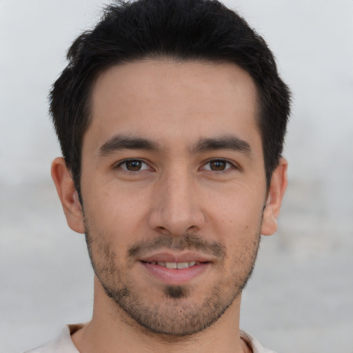 Joyful asian young-adult male with short  black hair and brown eyes