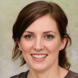 Joyful white young-adult female with medium  brown hair and blue eyes