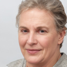 Joyful white adult female with medium  brown hair and blue eyes