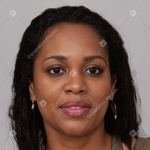 Joyful black adult female with long  brown hair and brown eyes