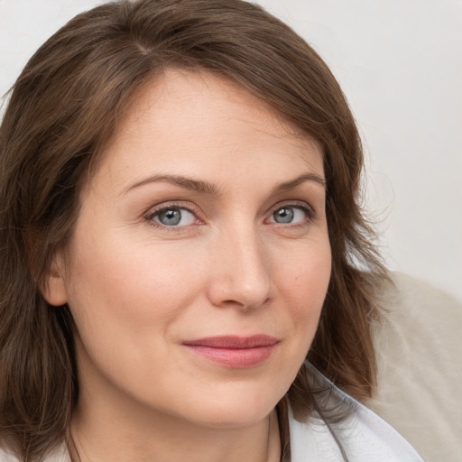 Joyful white young-adult female with medium  brown hair and blue eyes