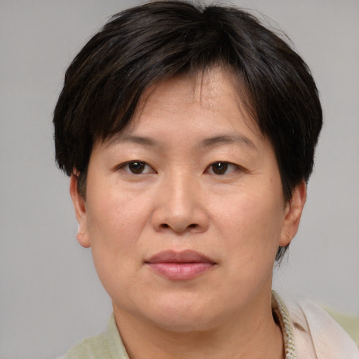 Joyful asian adult female with short  brown hair and brown eyes