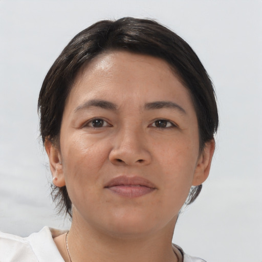 Joyful asian young-adult female with short  brown hair and brown eyes