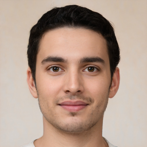 Joyful white young-adult male with short  black hair and brown eyes