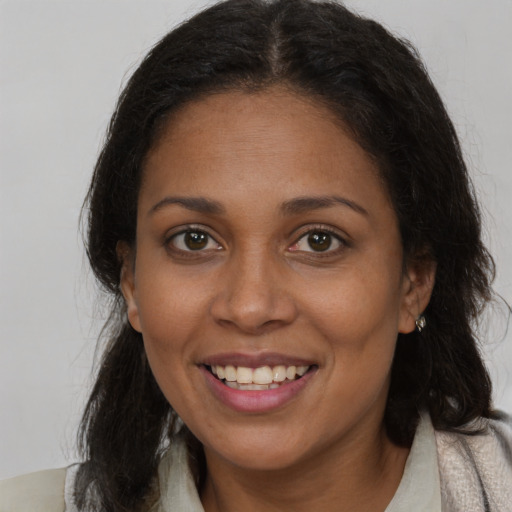 Joyful black young-adult female with medium  brown hair and brown eyes