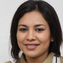 Joyful latino young-adult female with medium  brown hair and brown eyes