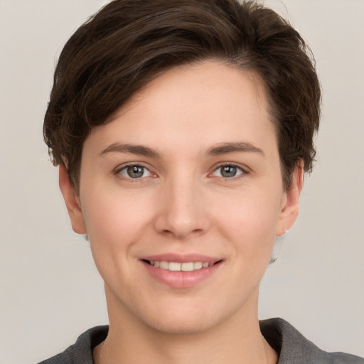 Joyful white young-adult female with short  brown hair and grey eyes