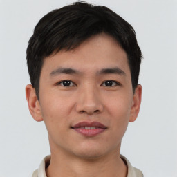 Joyful asian young-adult male with short  black hair and brown eyes