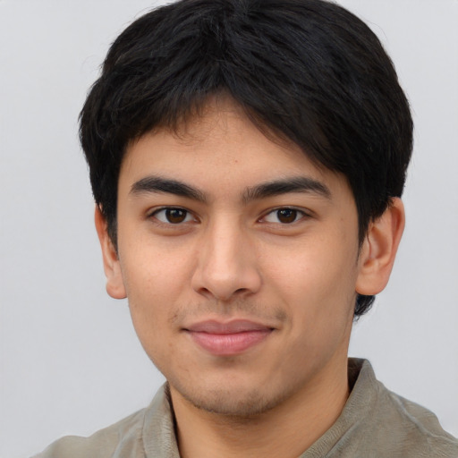 Joyful asian young-adult male with short  brown hair and brown eyes