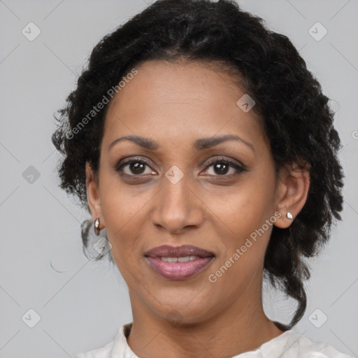 Joyful black adult female with medium  brown hair and brown eyes