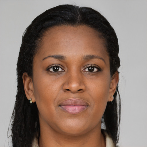 Joyful black young-adult female with long  brown hair and brown eyes