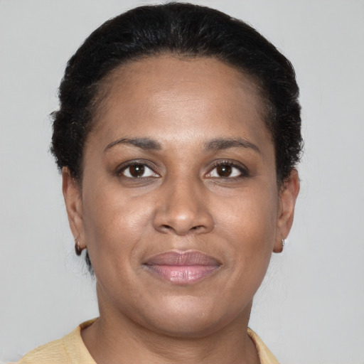 Joyful latino adult female with short  brown hair and brown eyes