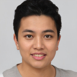 Joyful asian young-adult male with short  black hair and brown eyes