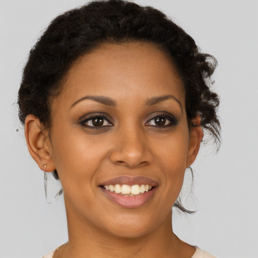 Joyful latino young-adult female with short  brown hair and brown eyes