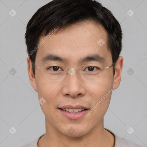 Joyful asian young-adult male with short  brown hair and brown eyes