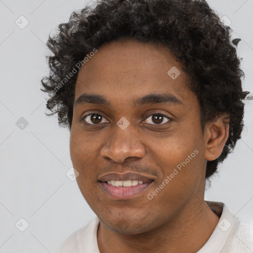 Joyful black young-adult male with short  black hair and brown eyes