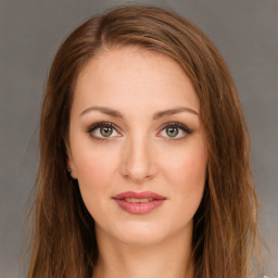 Joyful white young-adult female with long  brown hair and green eyes