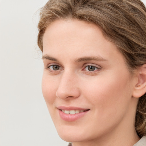 Joyful white young-adult female with medium  brown hair and blue eyes