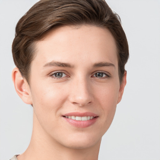 Joyful white young-adult female with short  brown hair and grey eyes