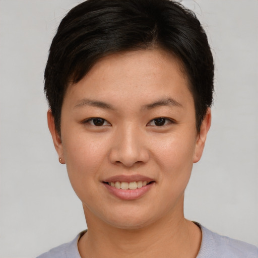Joyful asian young-adult female with short  brown hair and brown eyes