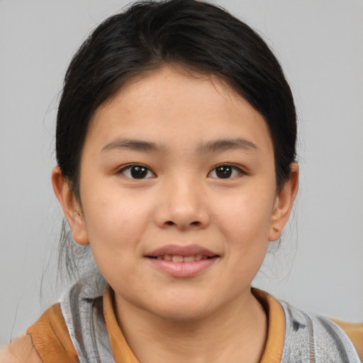 Joyful asian child female with medium  brown hair and brown eyes