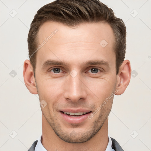 Joyful white young-adult male with short  brown hair and grey eyes