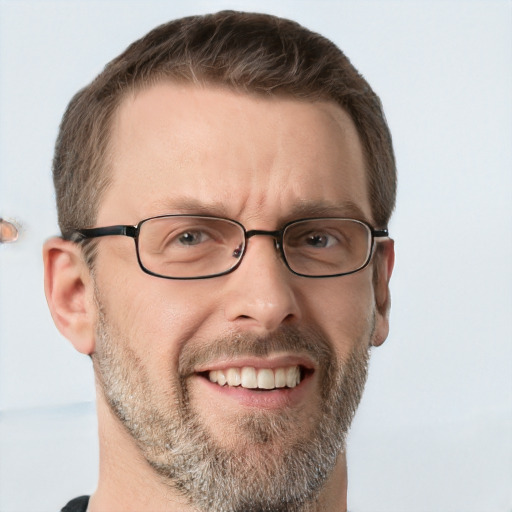 Joyful white adult male with short  brown hair and grey eyes