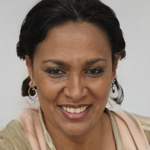 Joyful latino adult female with medium  brown hair and brown eyes