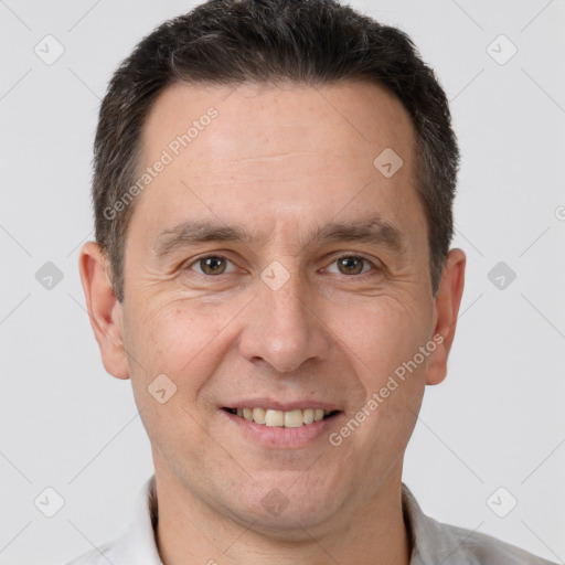 Joyful white adult male with short  brown hair and brown eyes