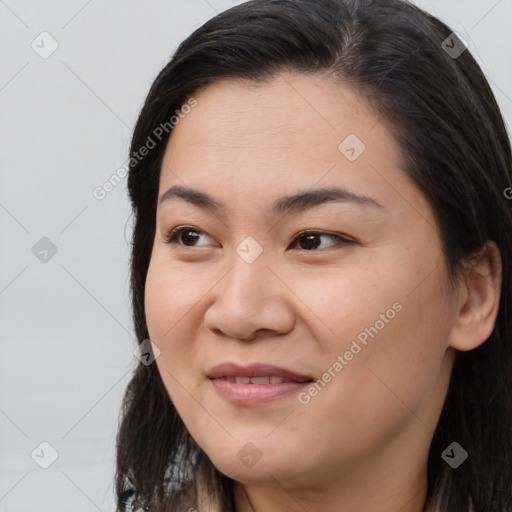 Joyful asian young-adult female with long  brown hair and brown eyes