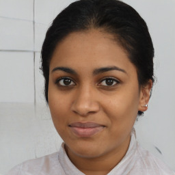 Joyful latino young-adult female with medium  brown hair and brown eyes