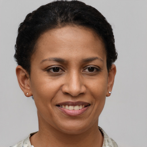 Joyful latino young-adult female with short  brown hair and brown eyes