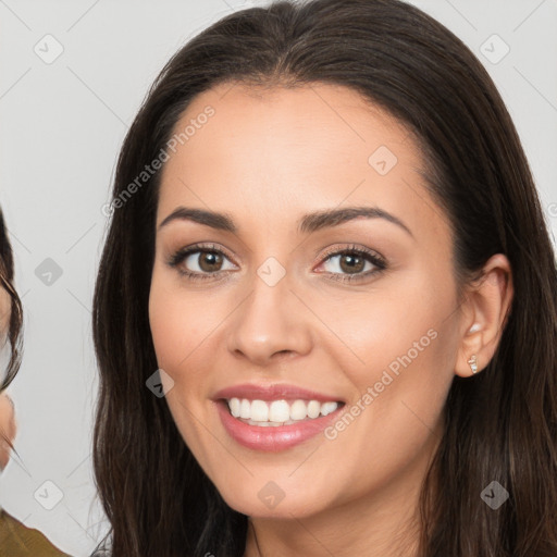 Joyful white young-adult female with long  brown hair and brown eyes