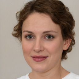 Joyful white young-adult female with medium  brown hair and green eyes