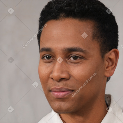 Joyful latino young-adult male with short  black hair and brown eyes