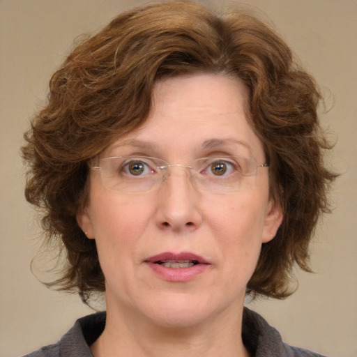 Joyful white adult female with medium  brown hair and blue eyes