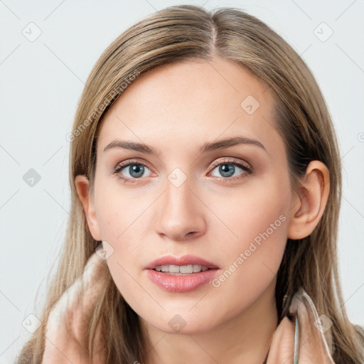 Joyful white young-adult female with long  brown hair and blue eyes