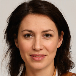 Joyful white adult female with long  brown hair and brown eyes