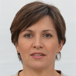 Joyful white adult female with short  brown hair and grey eyes